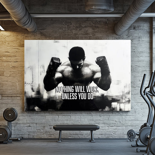 A black-and-white wall art print of a muscular boxer with clenched fists, accompanied by the motivational text "Nothing Will Work Unless You Do."