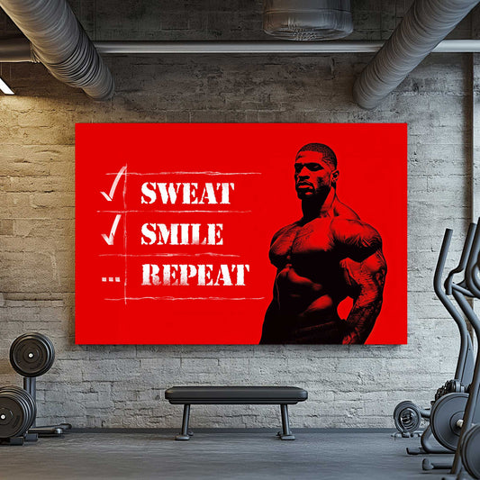 A metal print of a muscular figure on a bright red background with the text "Sweat Smile Repeat" in bold black-and-white typography.