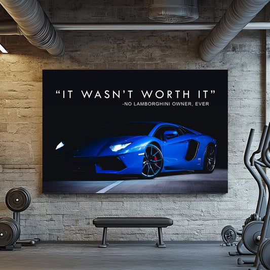 A sleek metal print of a blue Lamborghini photographed at night with illuminated headlights, accompanied by the text "It wasn’t worth it – no Lamborghini owner, ever."