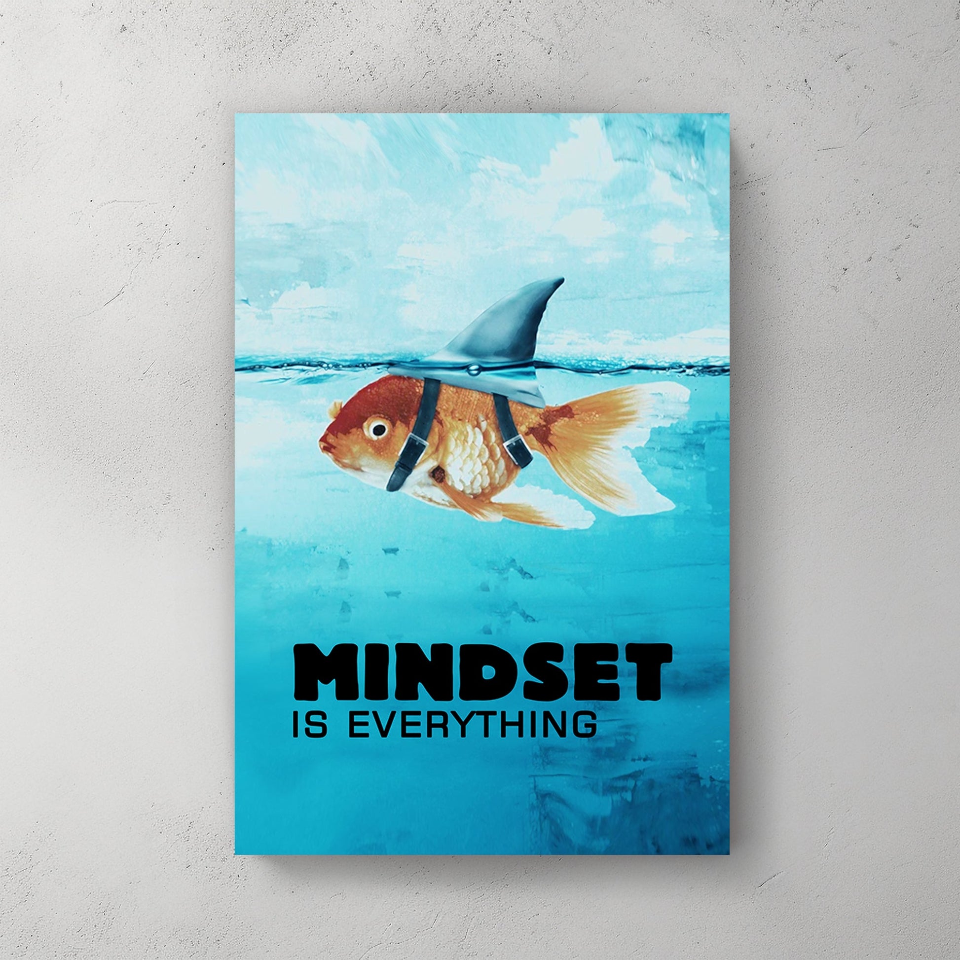 A metal print of a goldfish wearing a shark fin harness, swimming in a blue sea, embodying humour and inspiration.