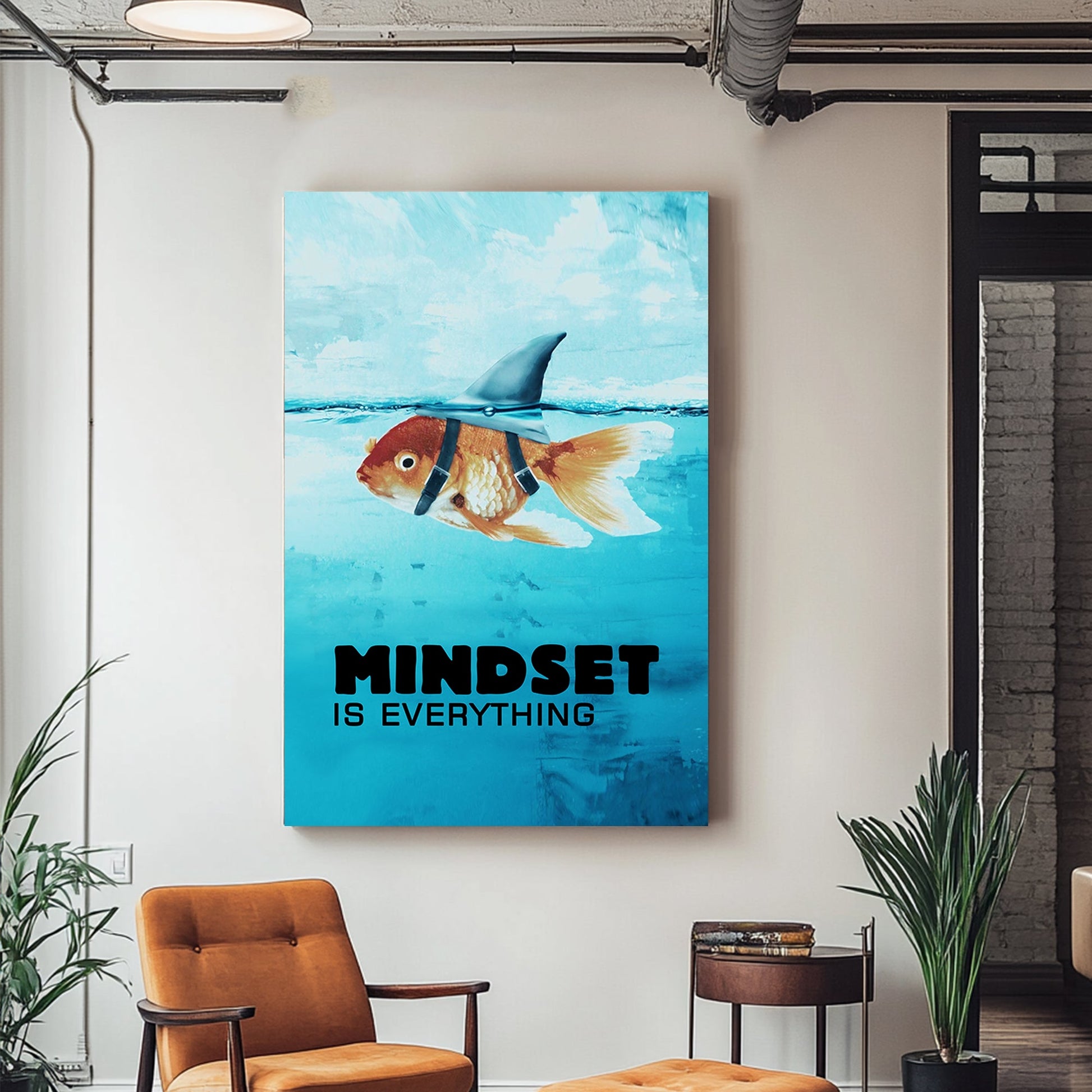 A metal print of a goldfish wearing a shark fin harness, swimming in a blue sea, embodying humour and inspiration.