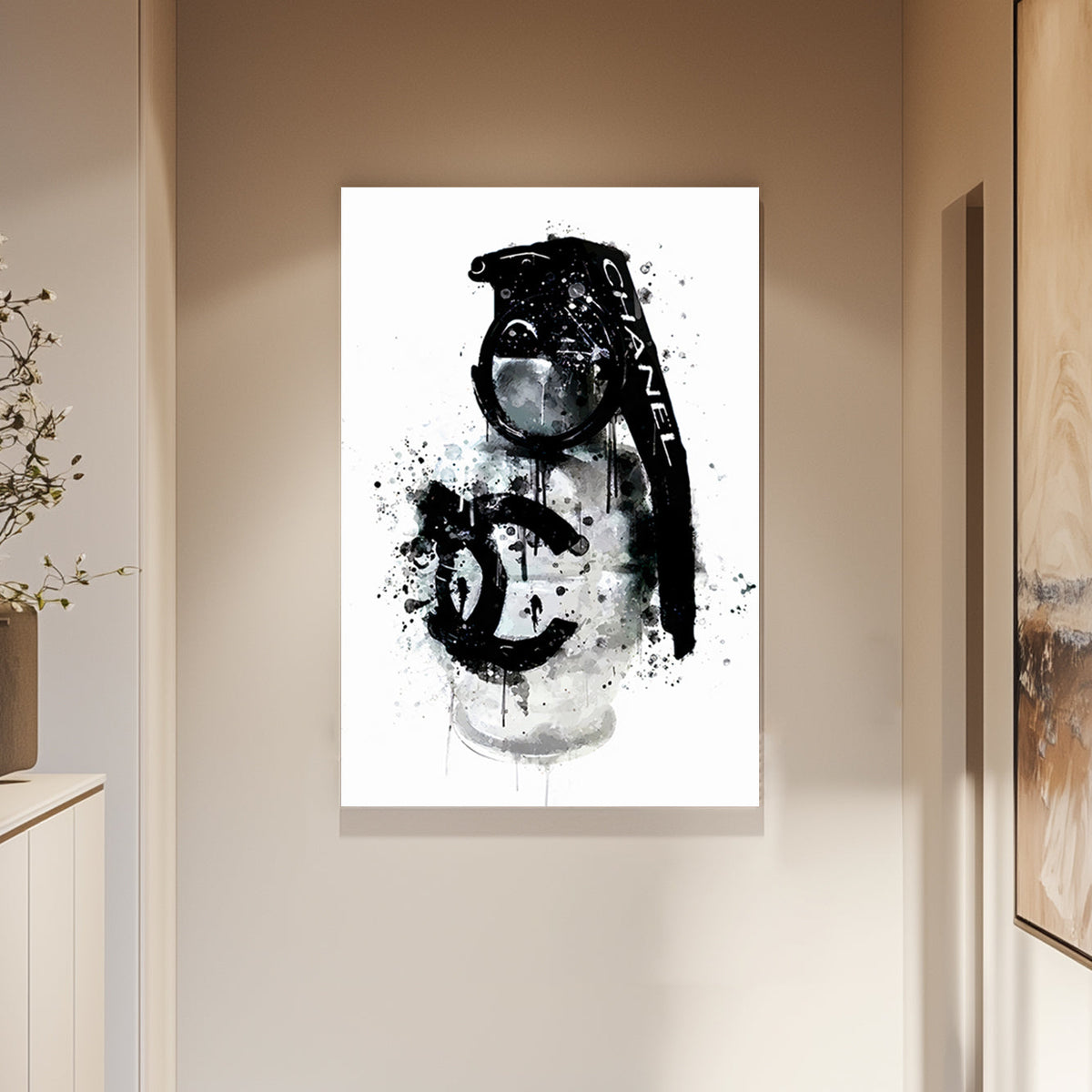 A wall art print of a Chanel branded grenade dripping with black ink splatters on a white background, combining luxury and chaos.