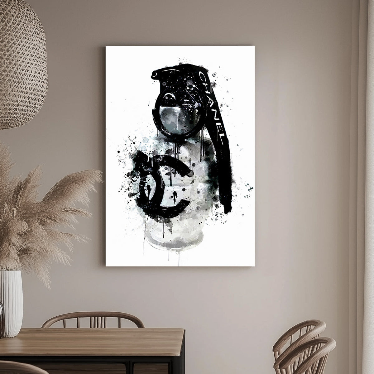 A wall art print of a Chanel branded grenade dripping with black ink splatters on a white background, combining luxury and chaos.