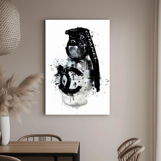 A wall art print of a Chanel branded grenade dripping with black ink splatters on a white background, combining luxury and chaos.