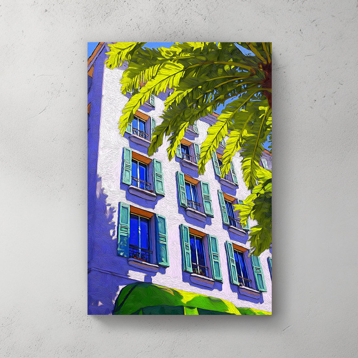 Brightly coloured wall art print of a Mediterranean-style building with green shutters and a palm tree, set against a vivid blue sky.