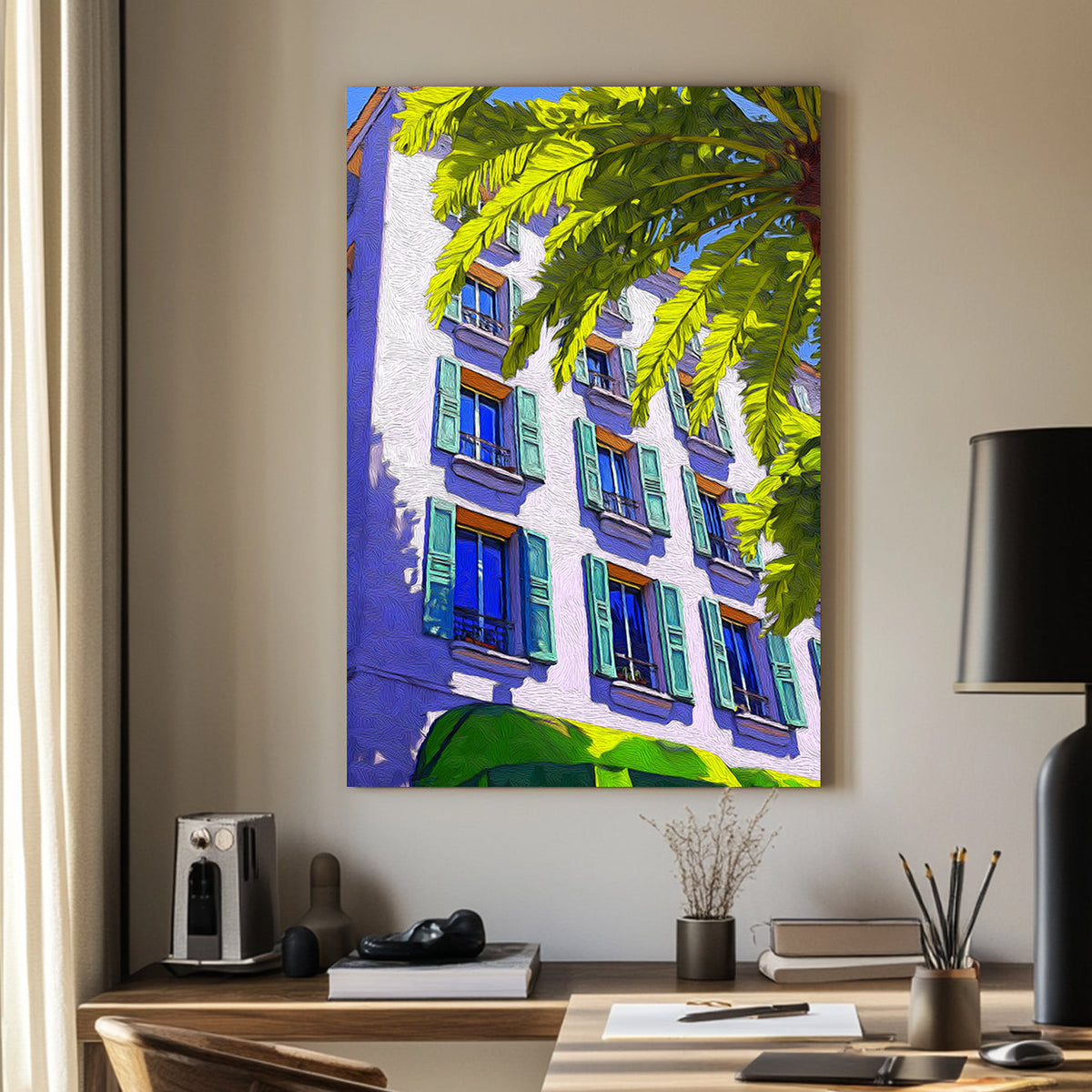 Brightly coloured wall art print of a Mediterranean-style building with green shutters and a palm tree, set against a vivid blue sky.