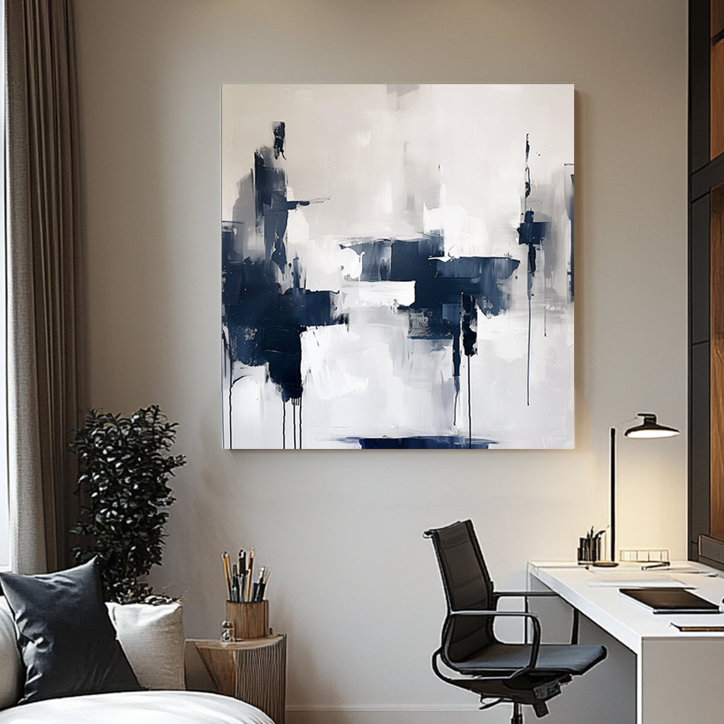 Abstract wall artwork featuring bold navy and white brushstrokes with dripped accents on a textured background.