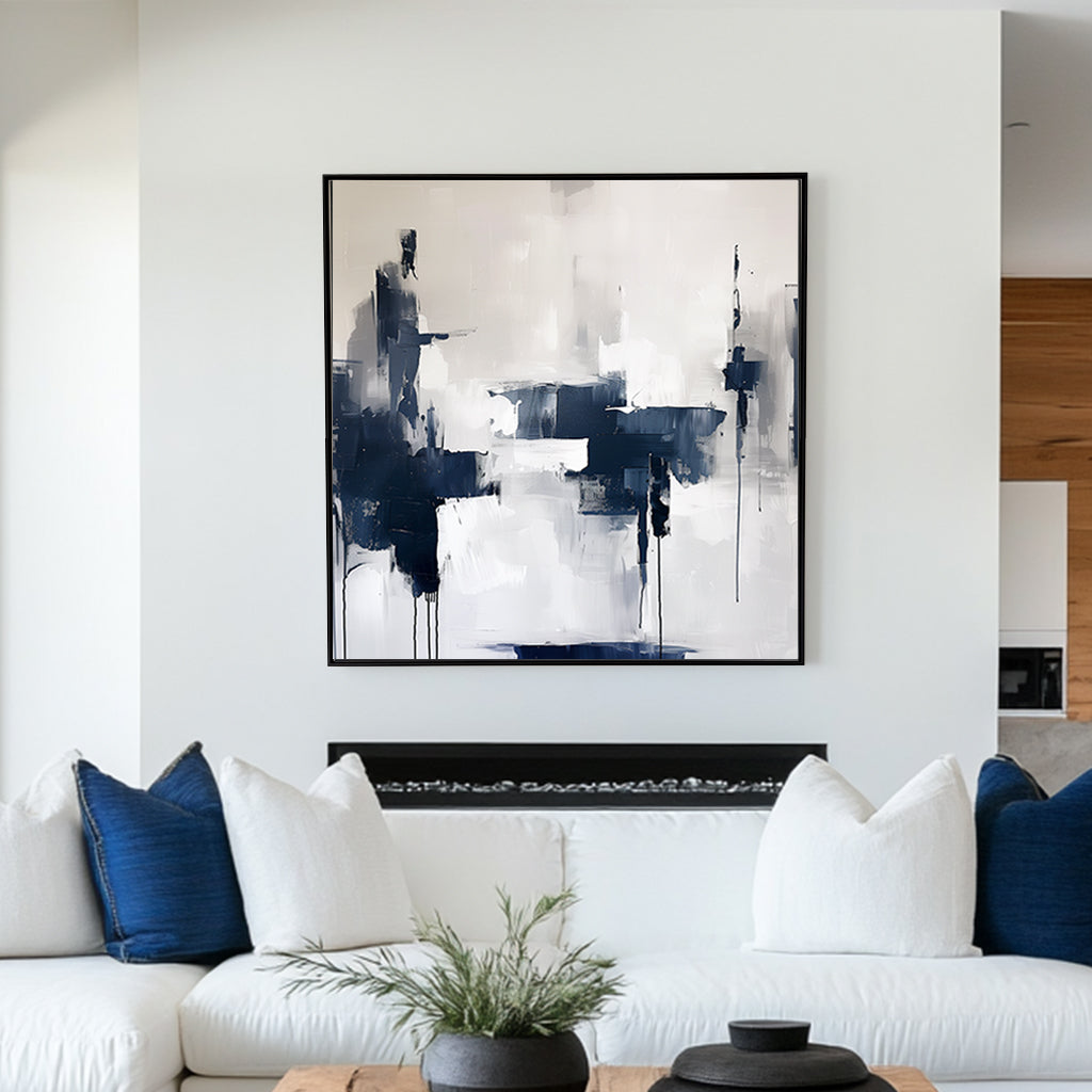 Abstract wall artwork featuring bold navy and white brushstrokes with dripped accents on a textured background.