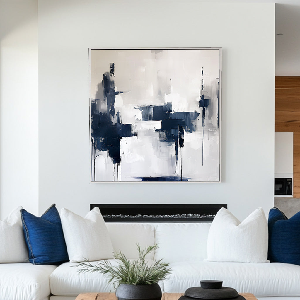 Abstract wall artwork featuring bold navy and white brushstrokes with dripped accents on a textured background.