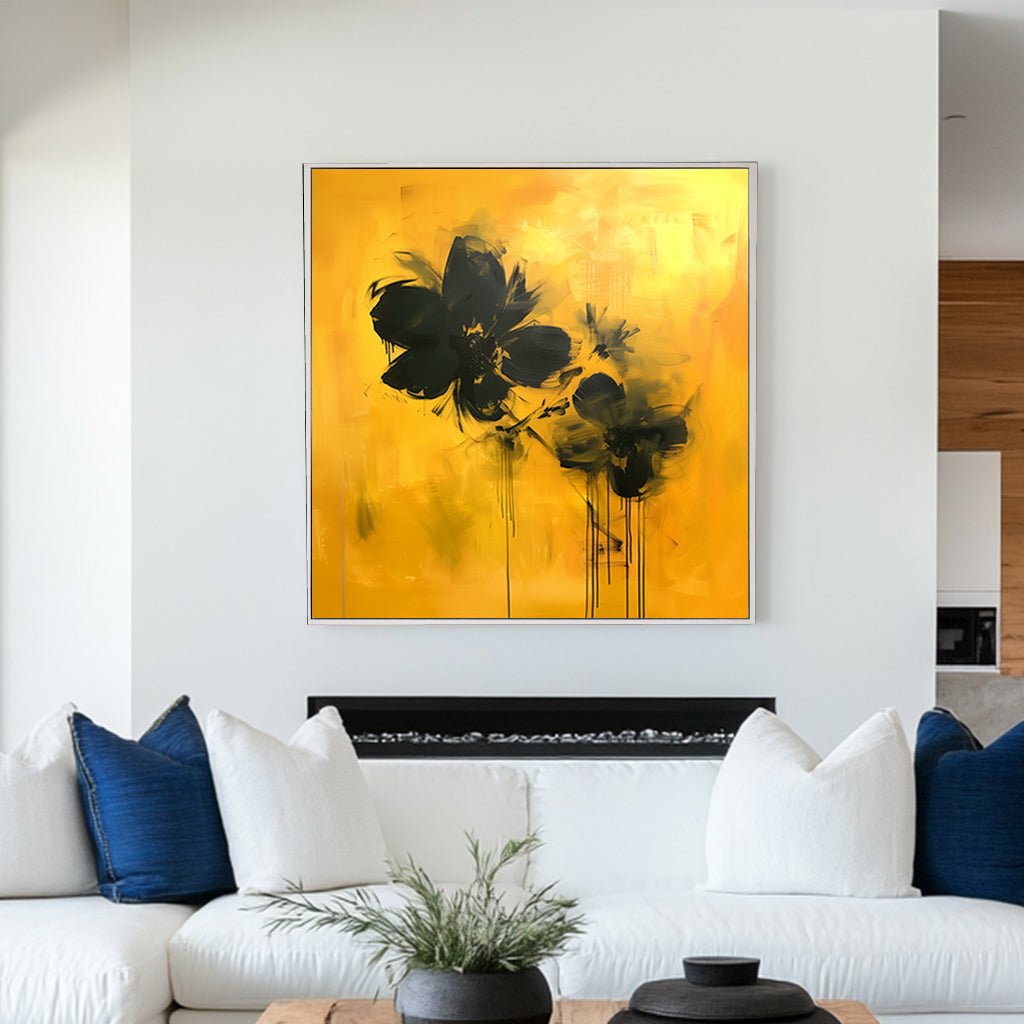 Abstract floral wall artwork featuring bold black flowers on a vivid yellow background with textured brushstrokes and dripping accents.