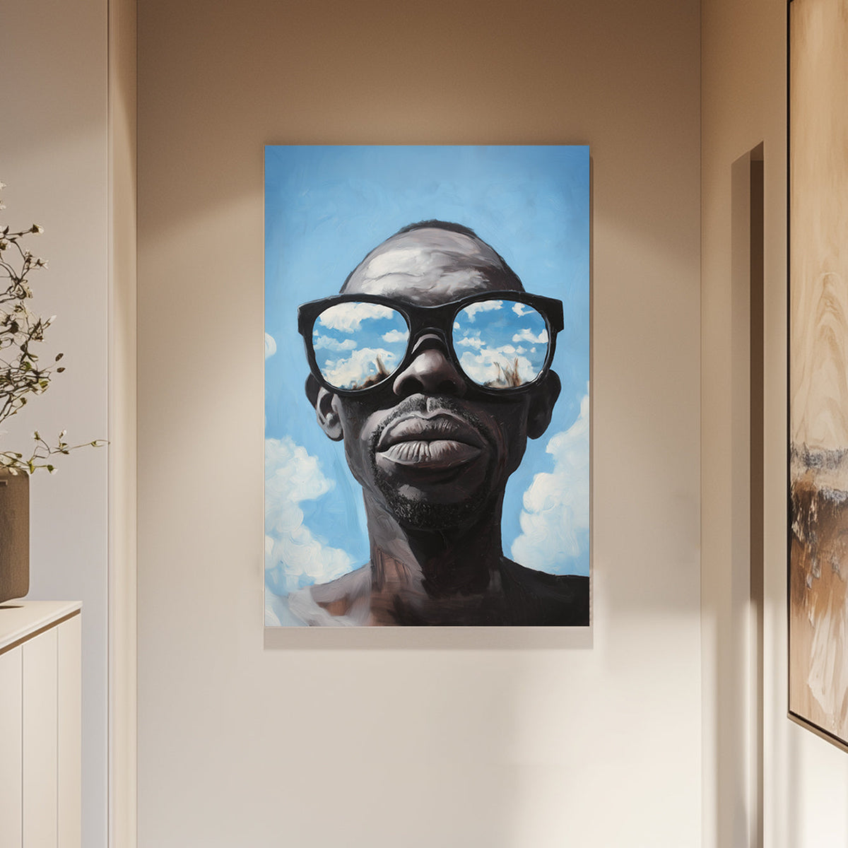 Hyper-realistic wall art print of a surrealism style of a man wearing sunglasses that reflect a vivid blue sky with clouds.