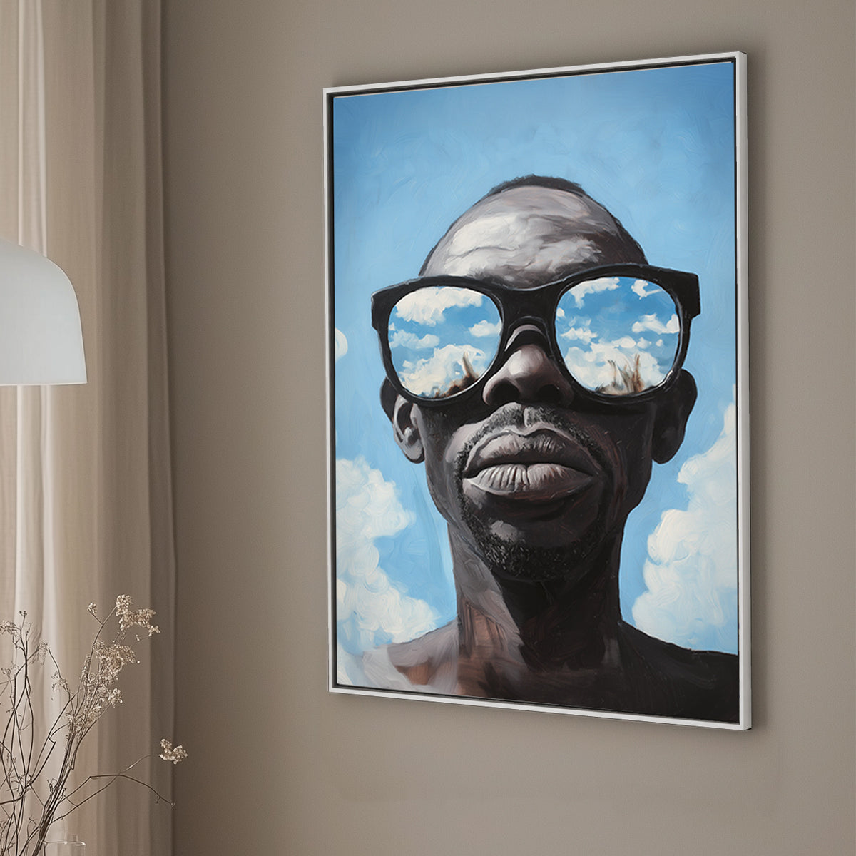 Hyper-realistic wall art print of a surrealism style of a man wearing sunglasses that reflect a vivid blue sky with clouds.