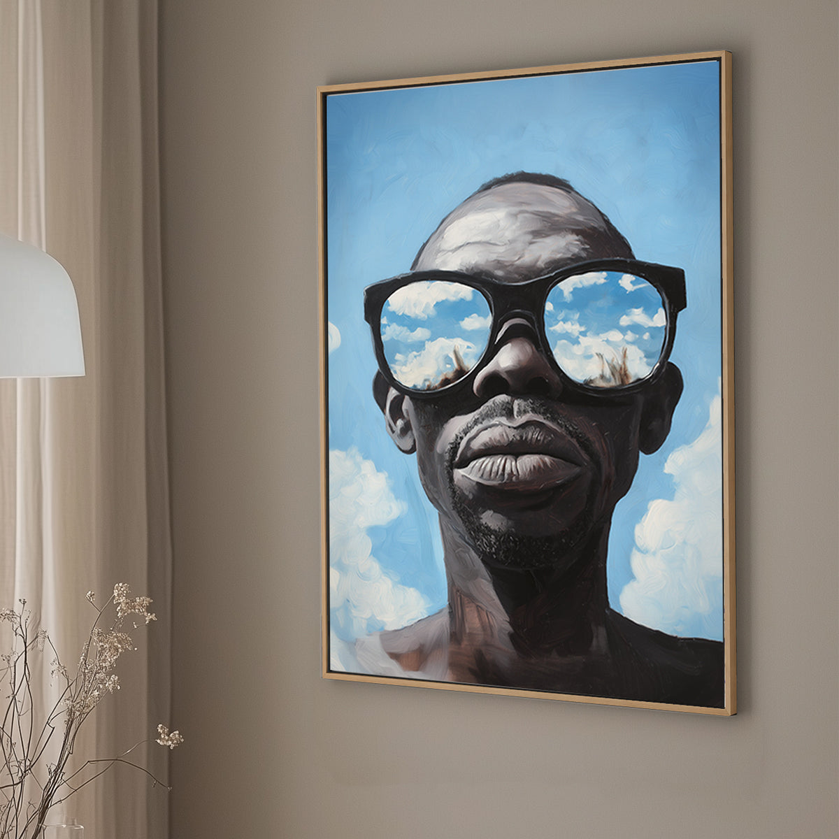 Hyper-realistic wall art print of a surrealism style of a man wearing sunglasses that reflect a vivid blue sky with clouds.