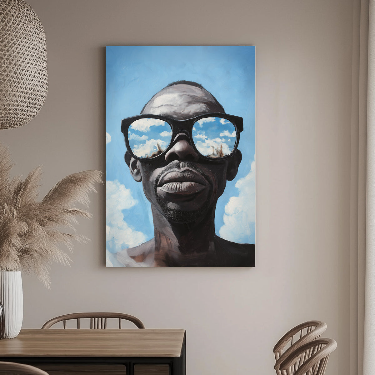 Hyper-realistic wall art print of a surrealism style of a man wearing sunglasses that reflect a vivid blue sky with clouds.