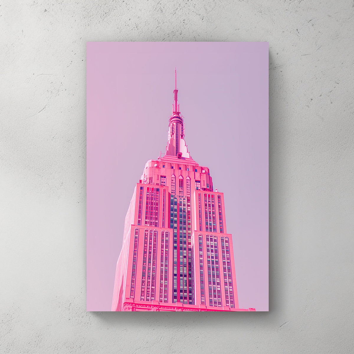 A pink wall art print of the Empire State Building in soft pink tones against a pastel background, showcasing minimalistic modern architecture.