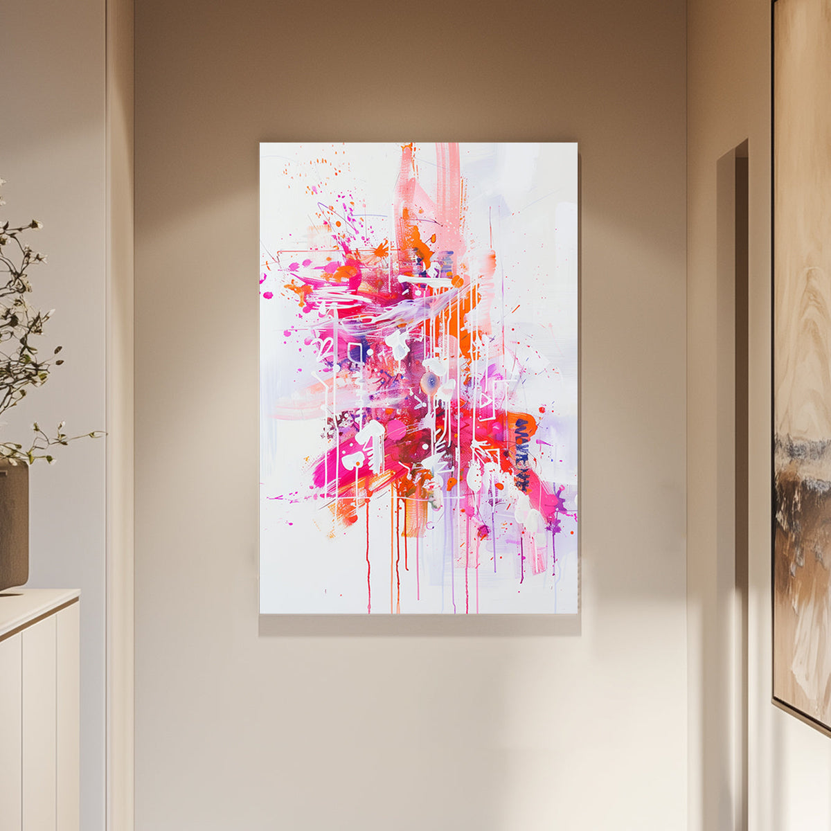 Abstract wall art featuring vivid splashes of pink, orange, and white, with dripping textures on a white canvas.