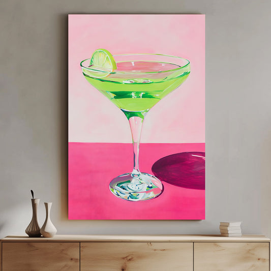 Vibrant wall art print of a green cocktail with a lime wedge in a martini glass, set against a pink background, perfect for adding a splash of color and zest to any space.