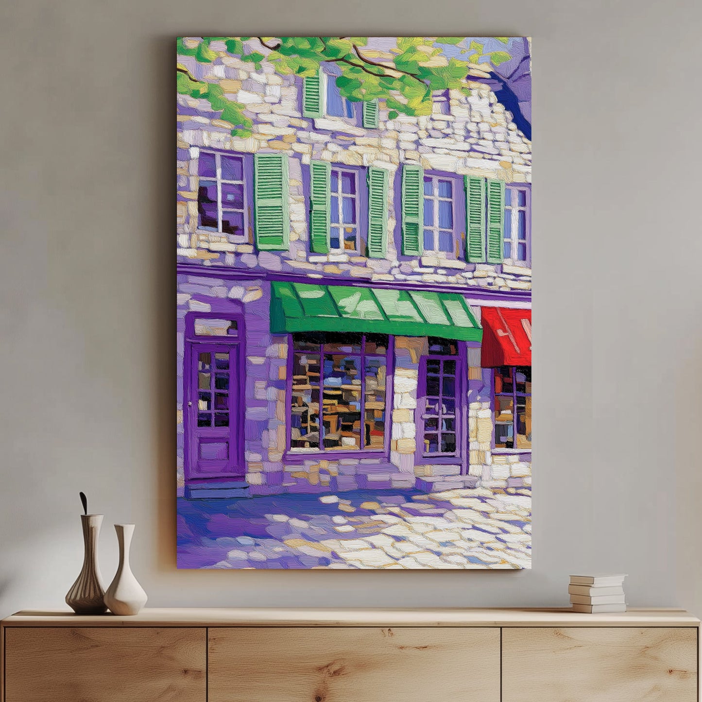 Impressionist-style wall art print of a European street scene with colorful storefronts and stone buildings, under a canopy of lush green leaves.