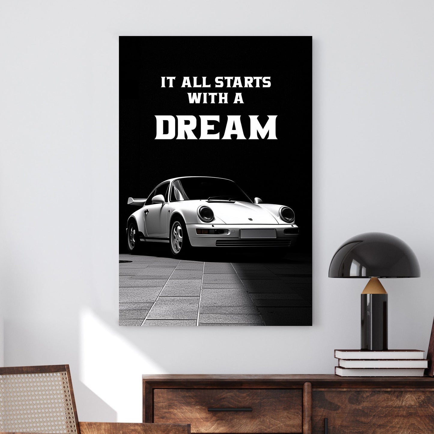 A striking black-and-white digital wall art print featuring a classic white sports car under dramatic lighting, accompanied by the bold motivational quote, “It all starts with a DREAM.”