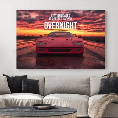 A bold digital wall art print of a red Ferrari F40 facing forward under a dramatic sunset, with motivational typography emphasizing dedication and perseverance.