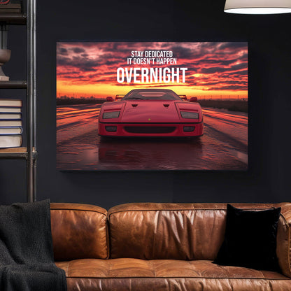 A bold digital wall art print of a red Ferrari F40 facing forward under a dramatic sunset, with motivational typography emphasizing dedication and perseverance.