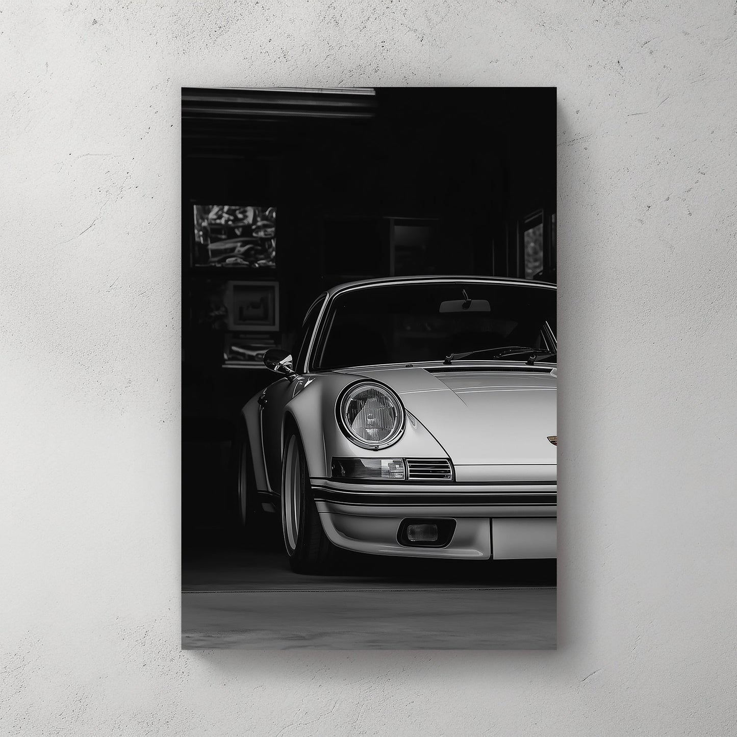 A black-and-white digital wall art print of a silver Porsche emerging from the shadows of a dimly lit garage, showcasing its refined curves and elegance.