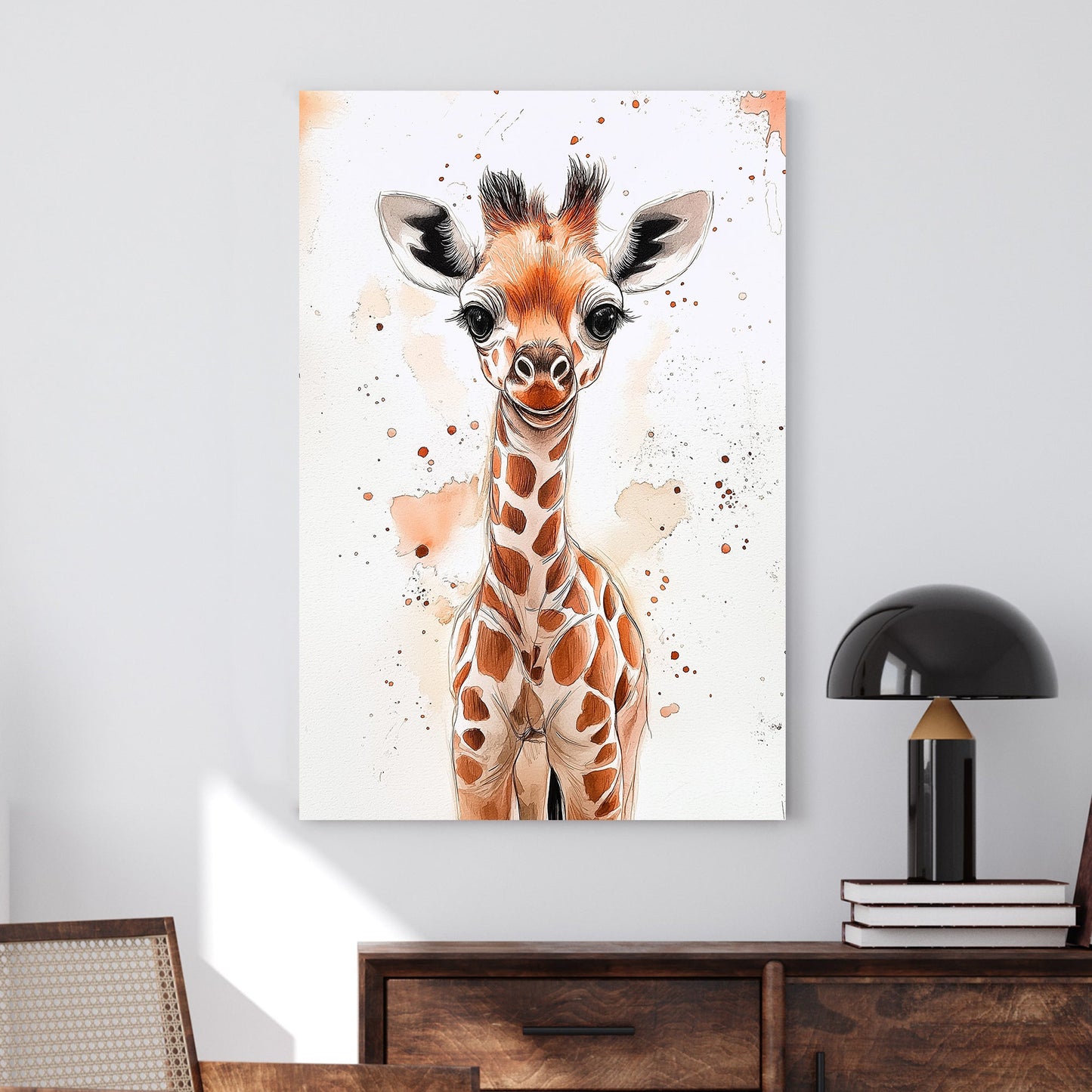 A charming watercolor and ink illustration of a baby giraffe with expressive eyes, soft brown tones, and playful paint splatters on a white background