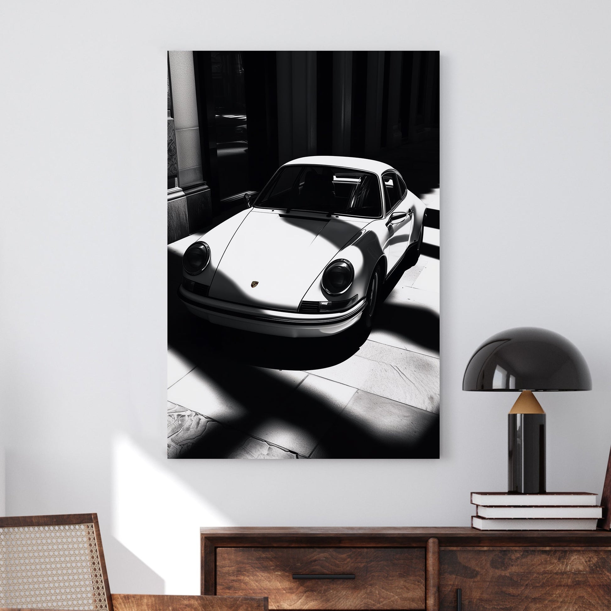 A striking black and white digital wall art print of a classic Porsche 911, captured in dramatic light and shadow, emphasizing its sleek design