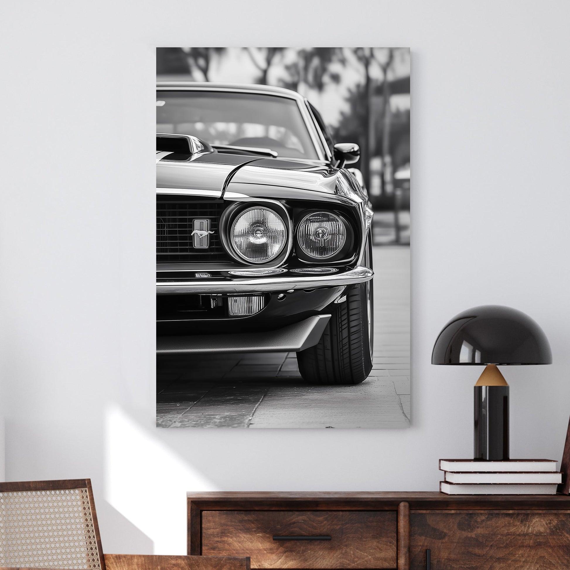 A striking black and white close-up of a classic Ford Mustang front grille and headlights, emphasizing vintage muscle car elegance and power.