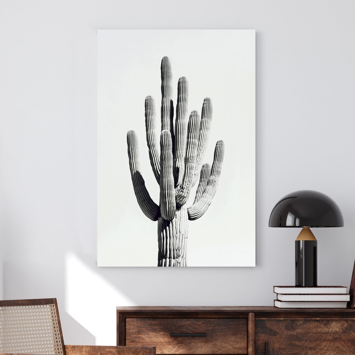 A black and white minimalistic wall art print of a towering saguaro cactus, highlighting its texture and natural elegance against a clean backdrop