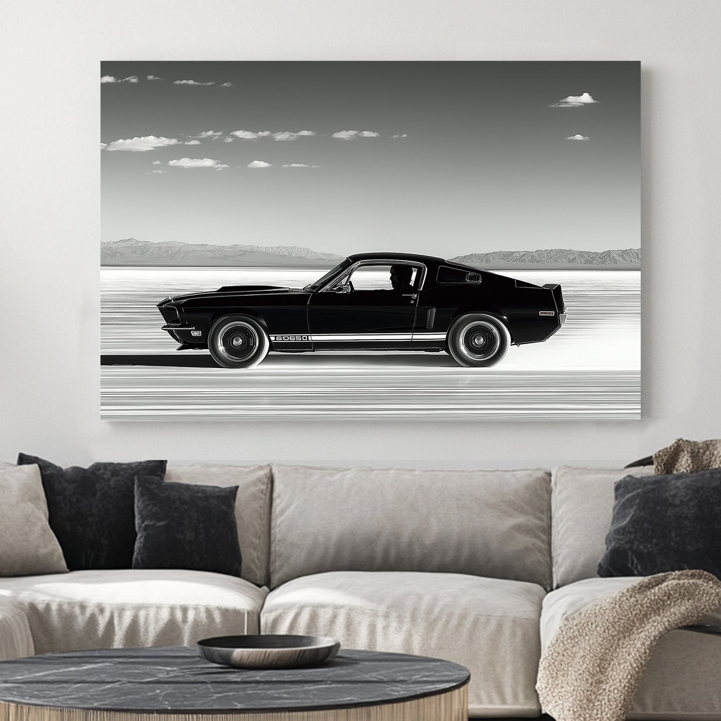 A black-and-white wall art print of a classic Ford Mustang speeding across the salt flats, with a vast open sky and distant mountains in the background.