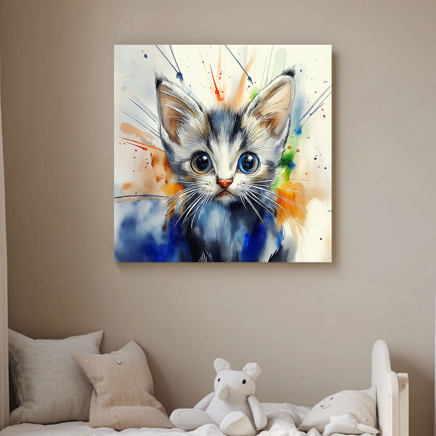 A whimsical watercolor-style wall art print of a kitten with one blue and one golden eye, surrounded by splashes of vibrant colours
