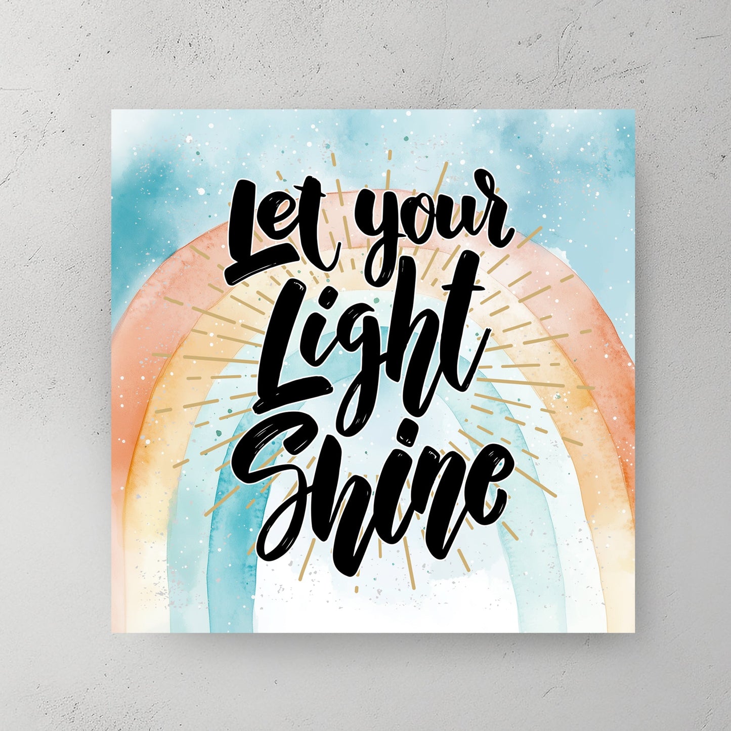 A motivational typography wall art print with the phrase “Let Your Light Shine” in bold script, set against a pastel watercolour rainbow with golden rays.