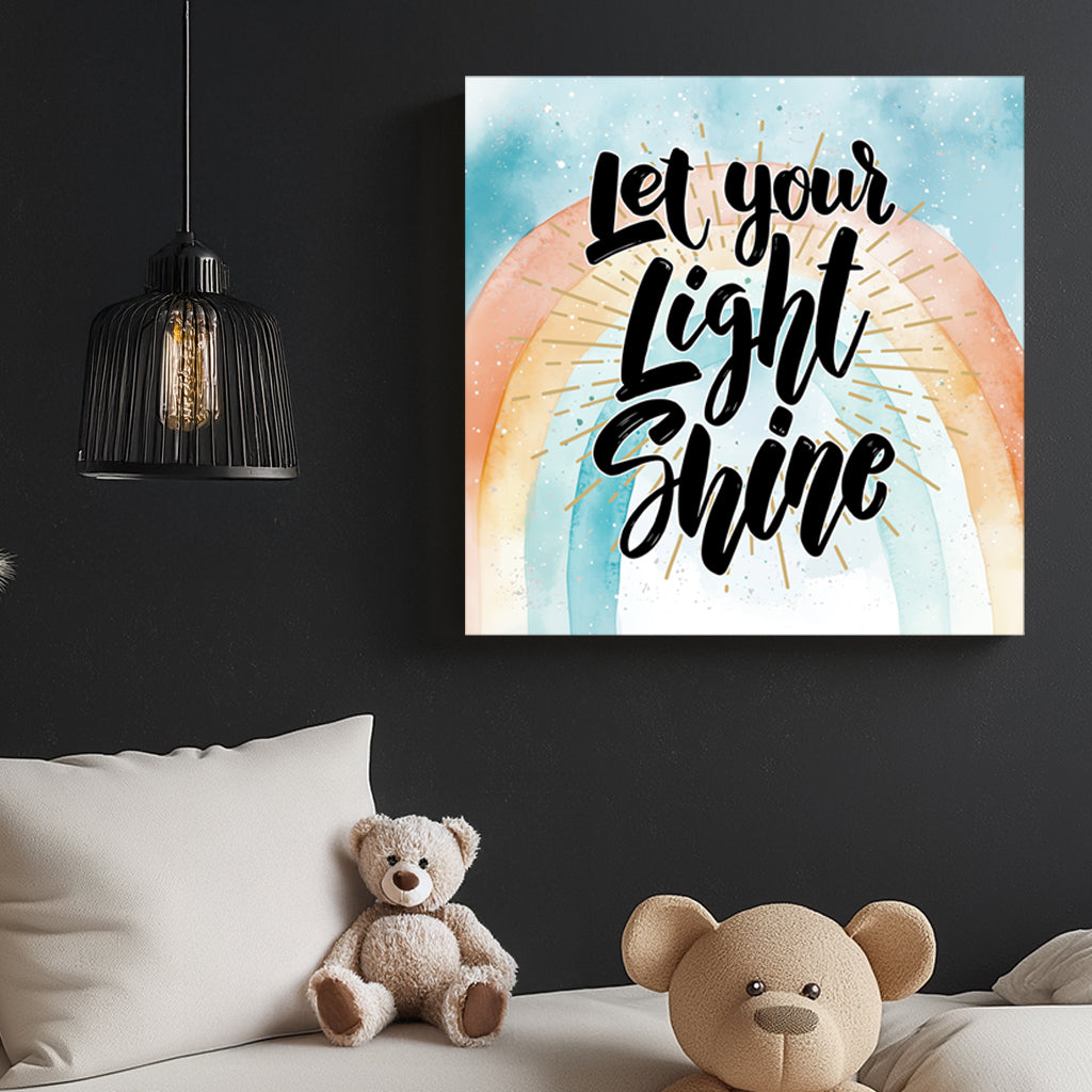 A motivational typography wall art print with the phrase “Let Your Light Shine” in bold script, set against a pastel watercolour rainbow with golden rays.