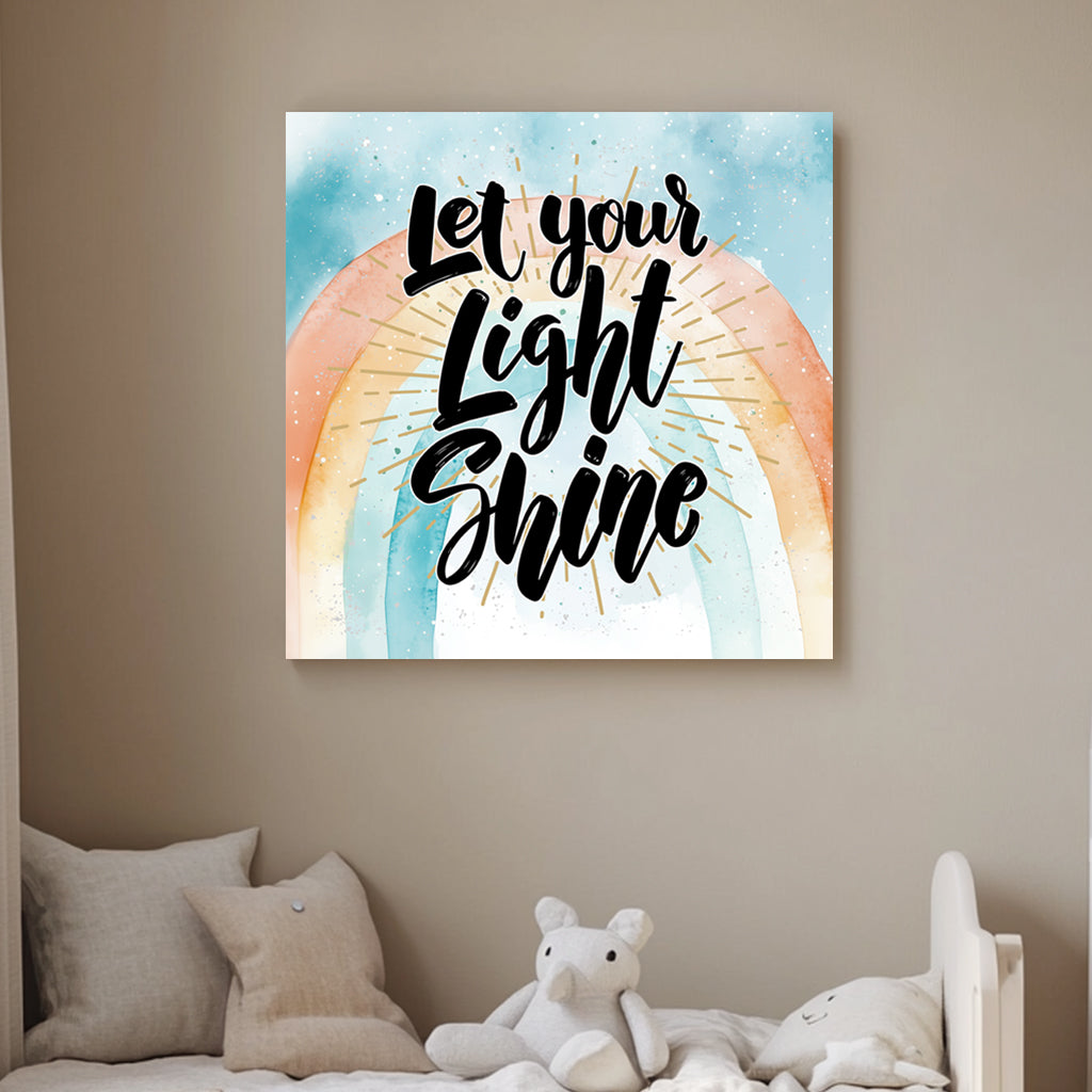 A motivational typography wall art print with the phrase “Let Your Light Shine” in bold script, set against a pastel watercolour rainbow with golden rays.