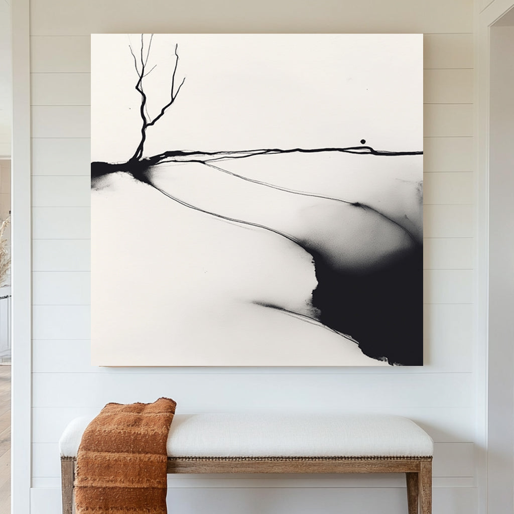 A minimalist black and white ink wall art print of a lone barren tree, set against an abstract landscape with fluid ink washes