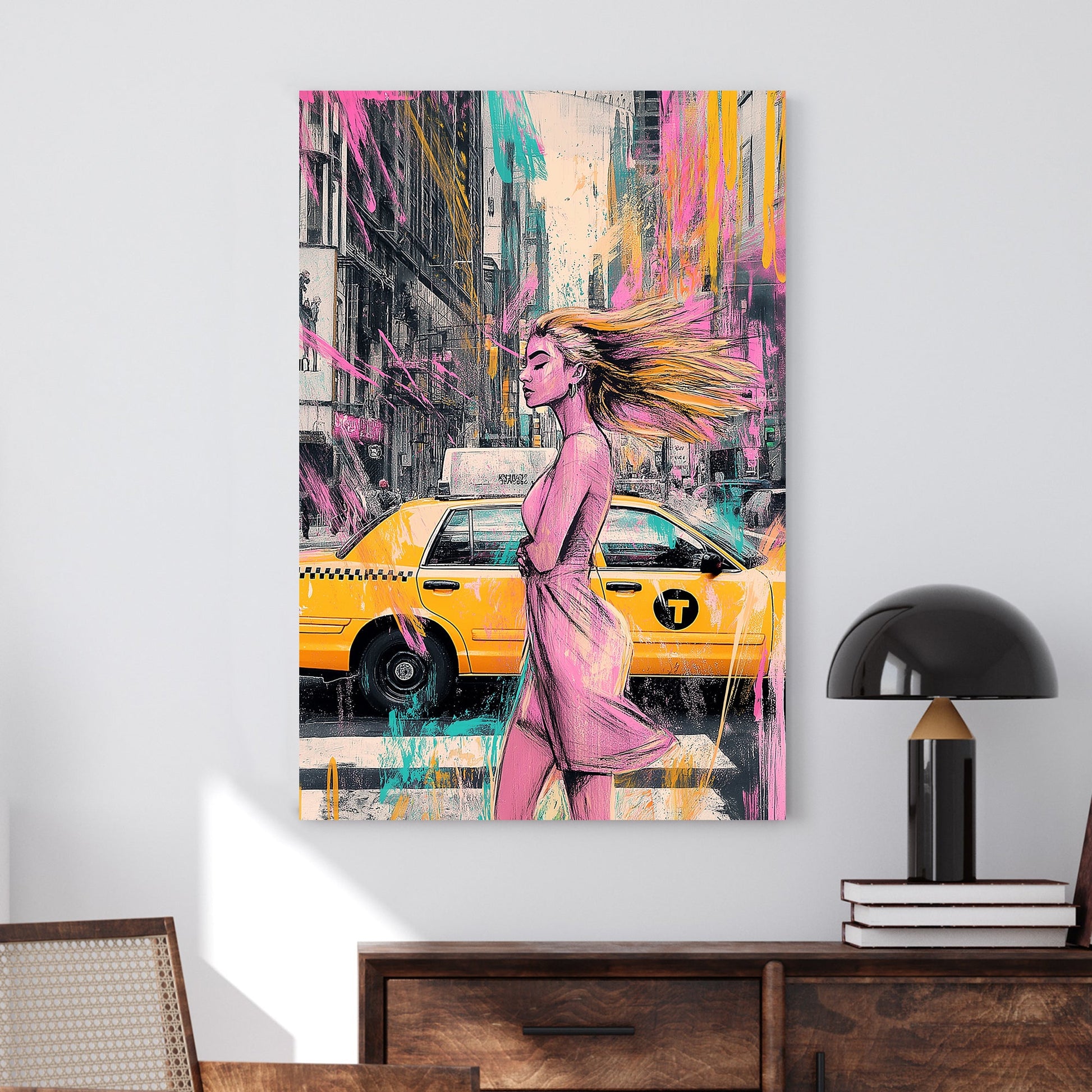 A modern urban wall art print featuring a stylish woman walking past a New York City yellow taxi, with splashes of pink, teal, and yellow graffiti-style elements.