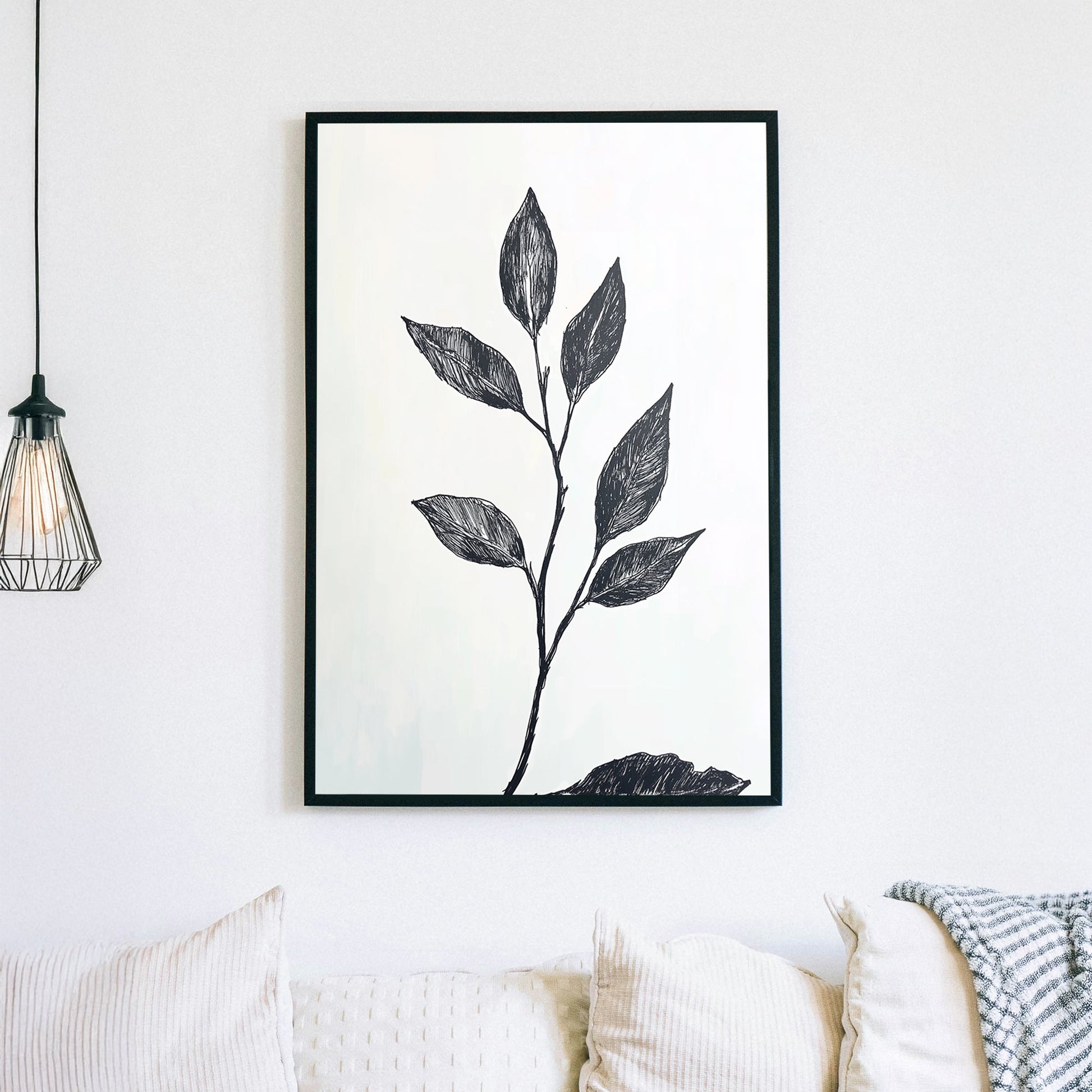 A minimalistic black and white botanical wall art print featuring a delicate hand-drawn branch with leaves, set against a light background