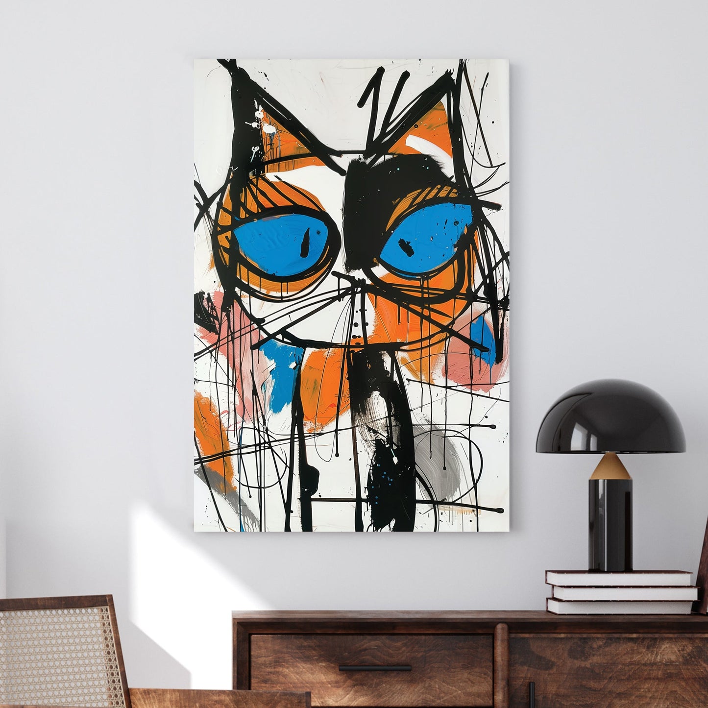 A bold abstract wall art print of a cat with piercing blue eyes, featuring dripping black strokes and vivid orange, pink, and blue accents in a graffiti-inspired style