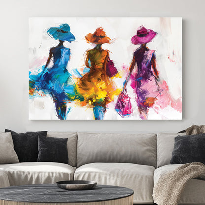 A contemporary wall art print of three stylish women in flowing blue, orange, and pink dresses, depicted with bold brushstrokes and textured layers