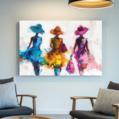 A contemporary wall art print of three stylish women in flowing blue, orange, and pink dresses, depicted with bold brushstrokes and textured layers