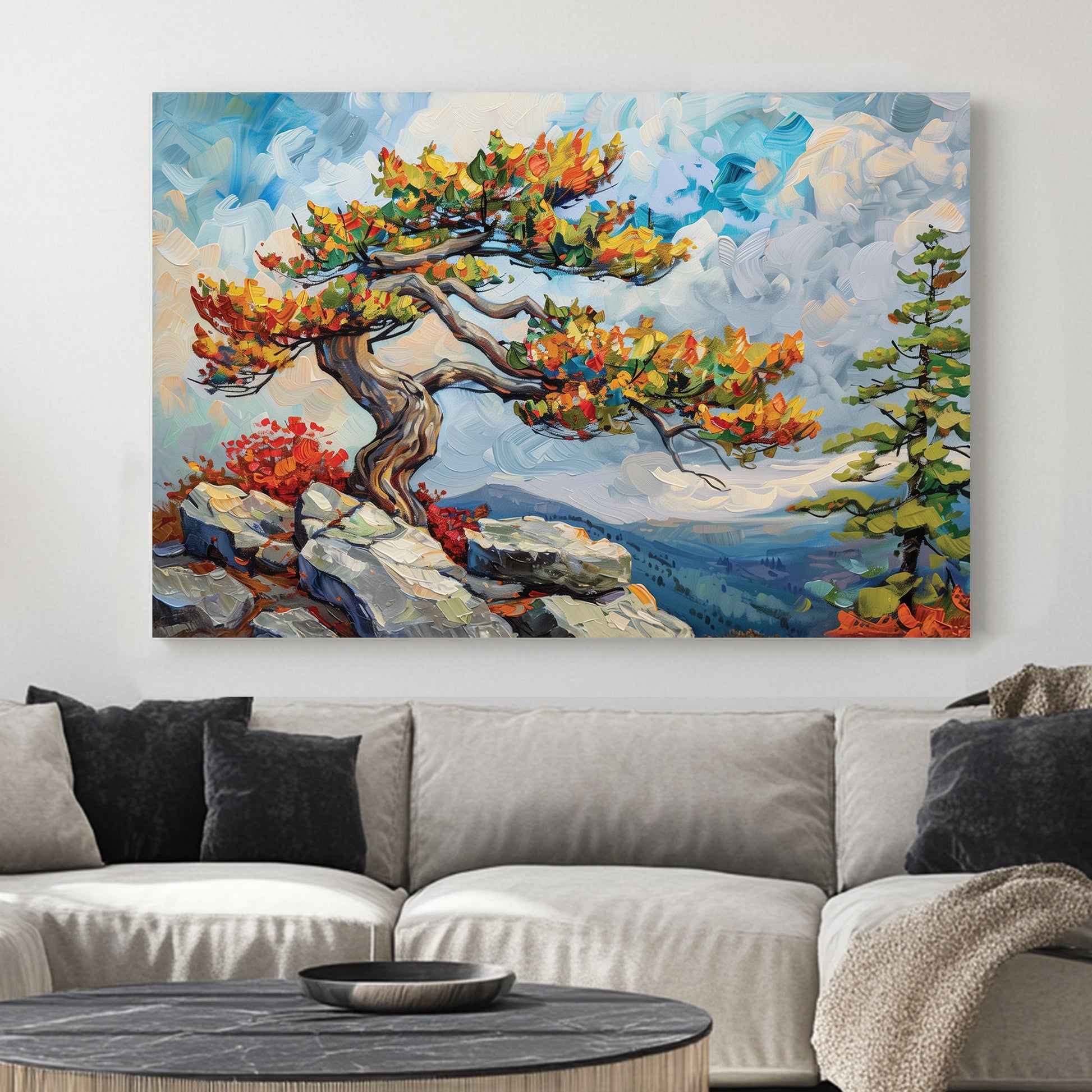 A striking oil wall art print of a twisted mountain tree with vibrant autumn leaves, standing on a rocky cliff against a vast, cloud-filled sky