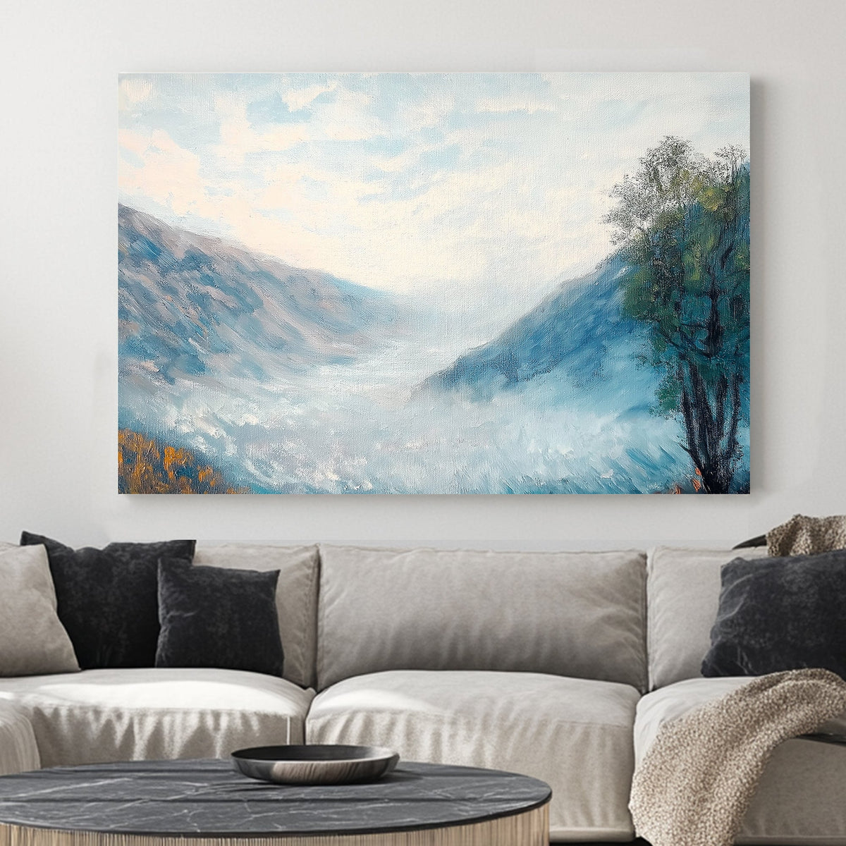 Impressionist wall art of a misty mountain valley with soft blue hues, rolling fog, and a lone autumn tree.