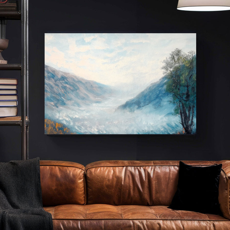 Impressionist wall art of a misty mountain valley with soft blue hues, rolling fog, and a lone autumn tree.
