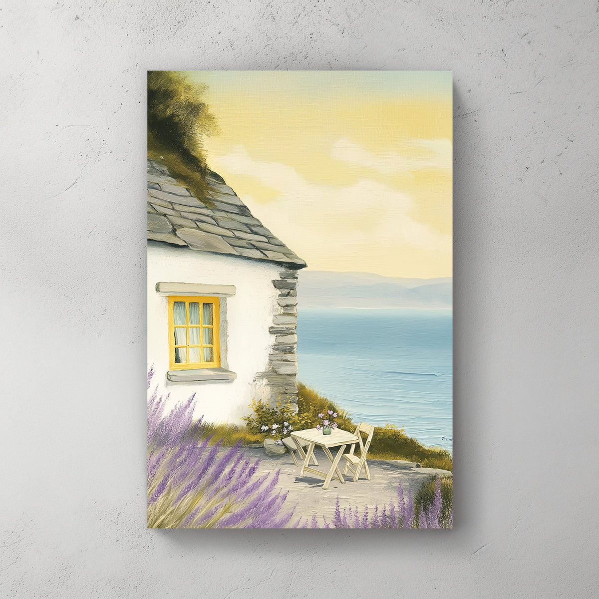 Oil-style wall art of a seaside cottage with a stone wall, lavender bushes, a table set for two, and a view of the ocean under a golden sky.