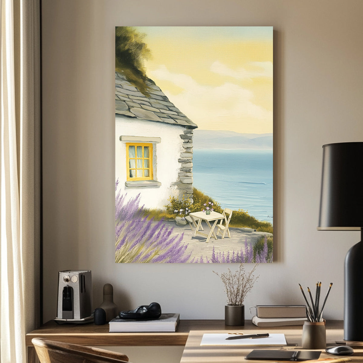 Oil-style wall art of a seaside cottage with a stone wall, lavender bushes, a table set for two, and a view of the ocean under a golden sky.