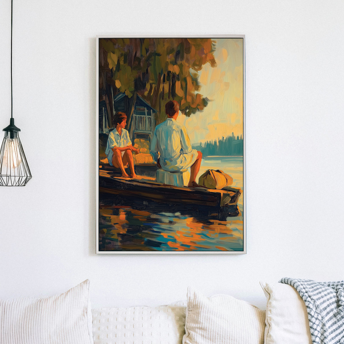 Oil-style wall art of a couple sitting on a wooden dock at sunset, with reflections on the water and a rustic cabin in the background.