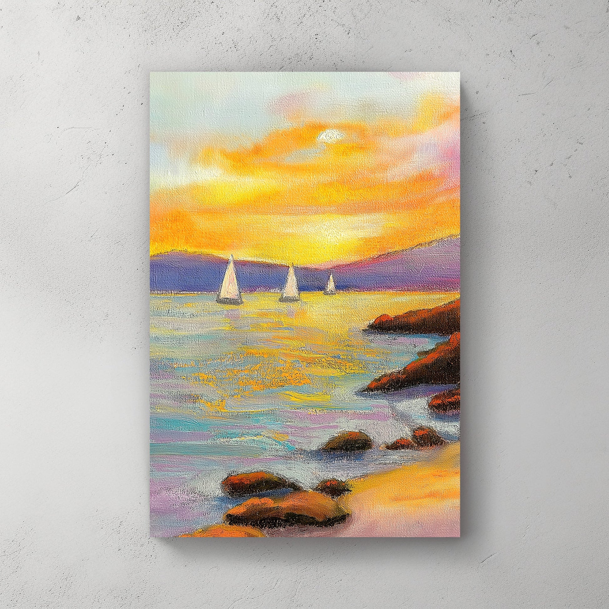 Vivid oil wall art of a sunset over the ocean, with sailboats in the distance and a rocky shoreline in the foreground.