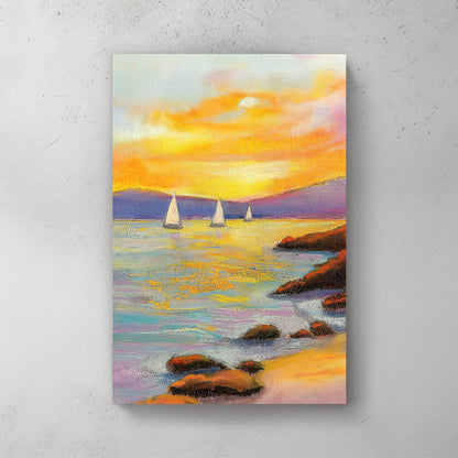 Vivid oil wall art of a sunset over the ocean, with sailboats in the distance and a rocky shoreline in the foreground.