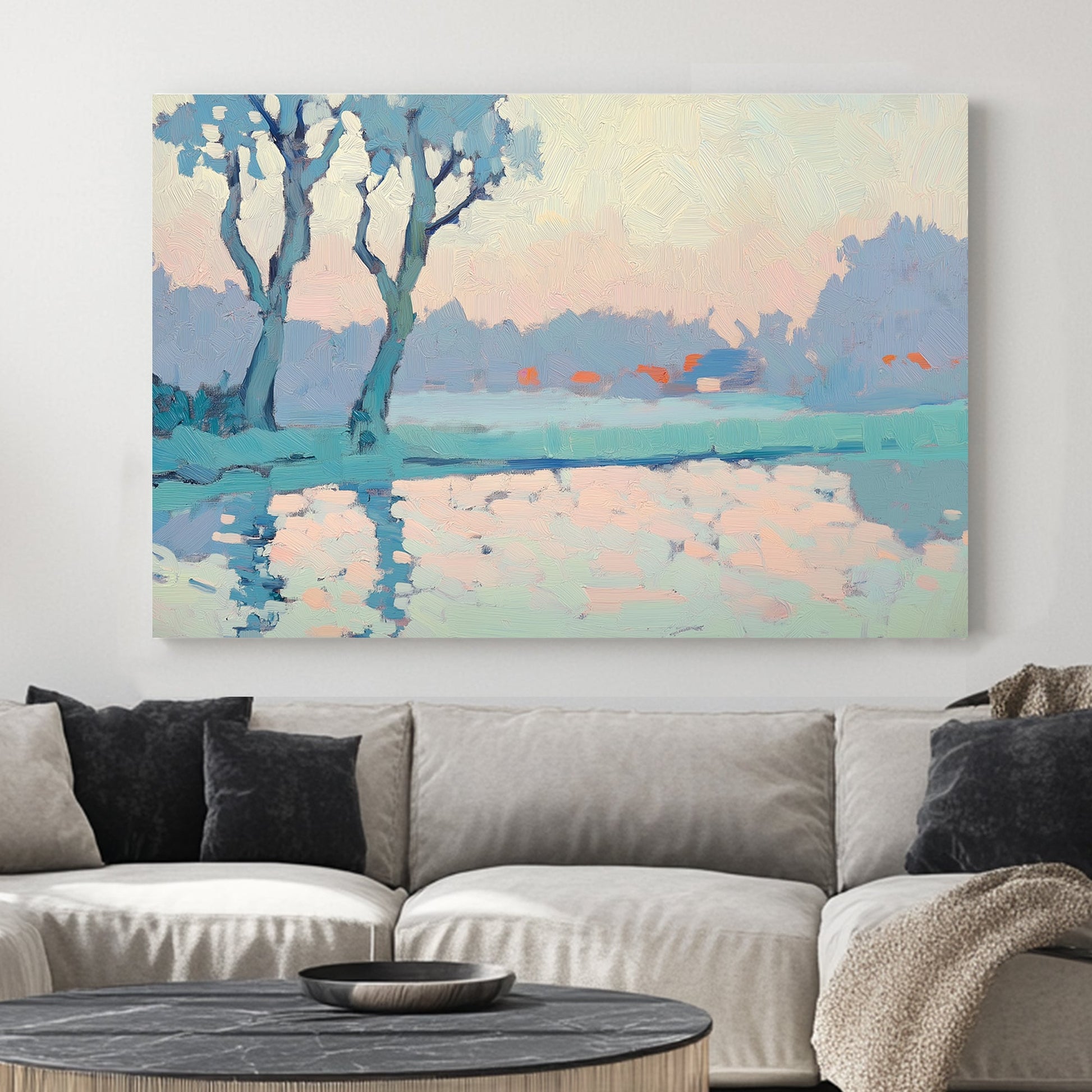 Impressionist wall art of trees reflecting on a calm lake at sunrise, in soft blue, peach, and pastel tones.